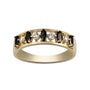 Gold ring with black and white gemstones on a white background