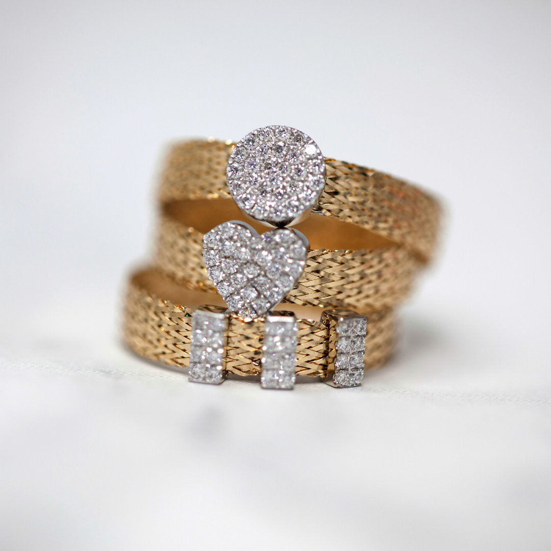 Gold and diamond rings on a white background