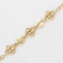 Gold chain bracelet on a light gray background