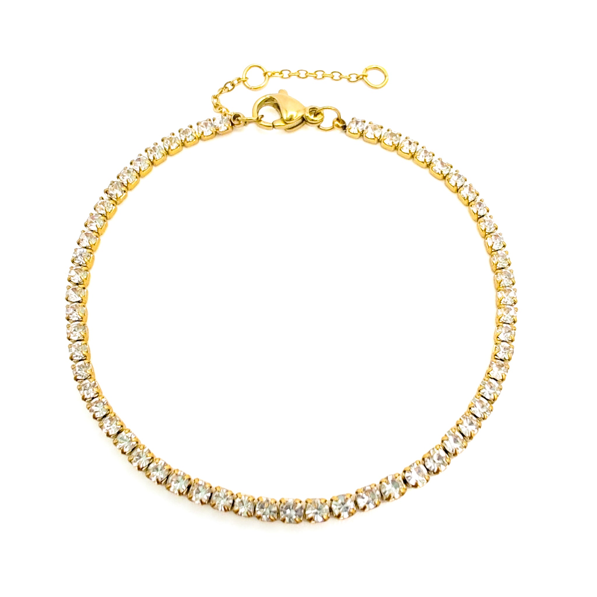 Gold bracelet with clear stones on a white background