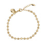 Gold bracelet with beaded design on a white background