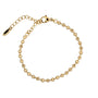Gold beaded bracelet on a white background