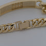 Gold chain bracelet on a light gray background