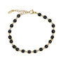 Gold bracelet with black evil eye charms on a white background
