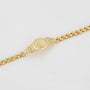 Gold bracelet on a light gray background