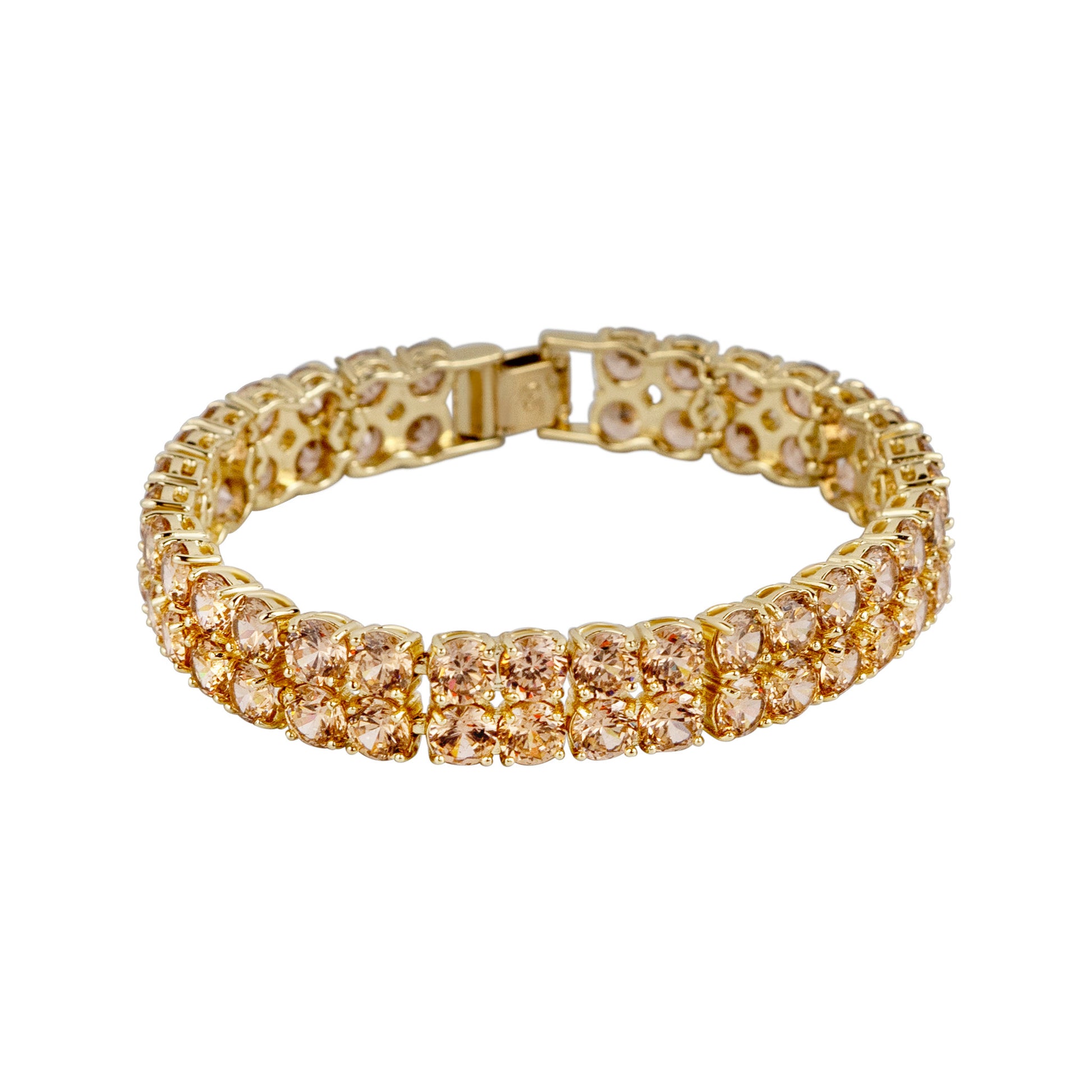 Gold bracelet with clear stones on a white background
