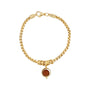 Gold bracelet with a round brown charm on a white background
