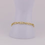 Gold bracelet with diamond accents on a light gray background