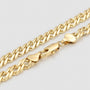 Gold chain necklace on a light gray background