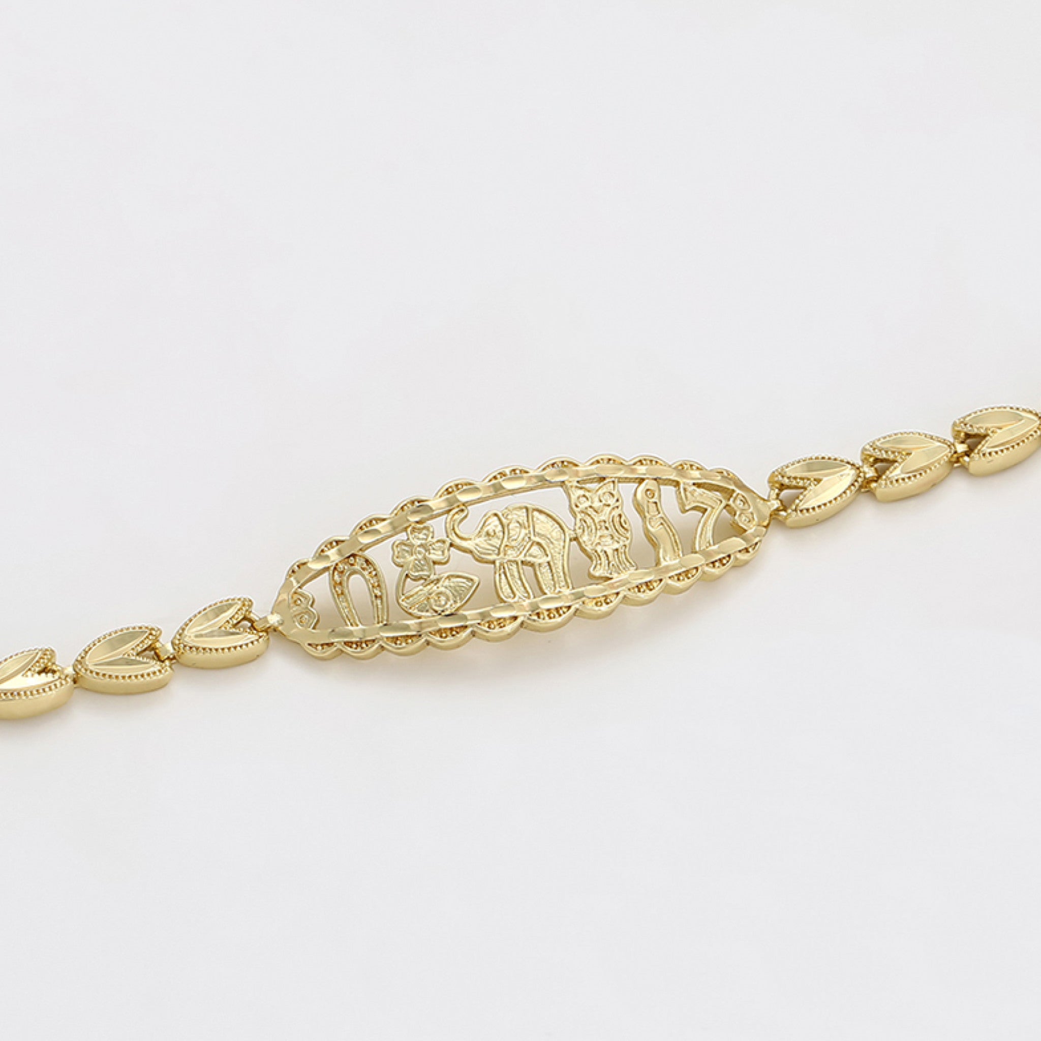 Gold bracelet with intricate design on a light gray background