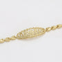 Gold bracelet with intricate design on a light gray background