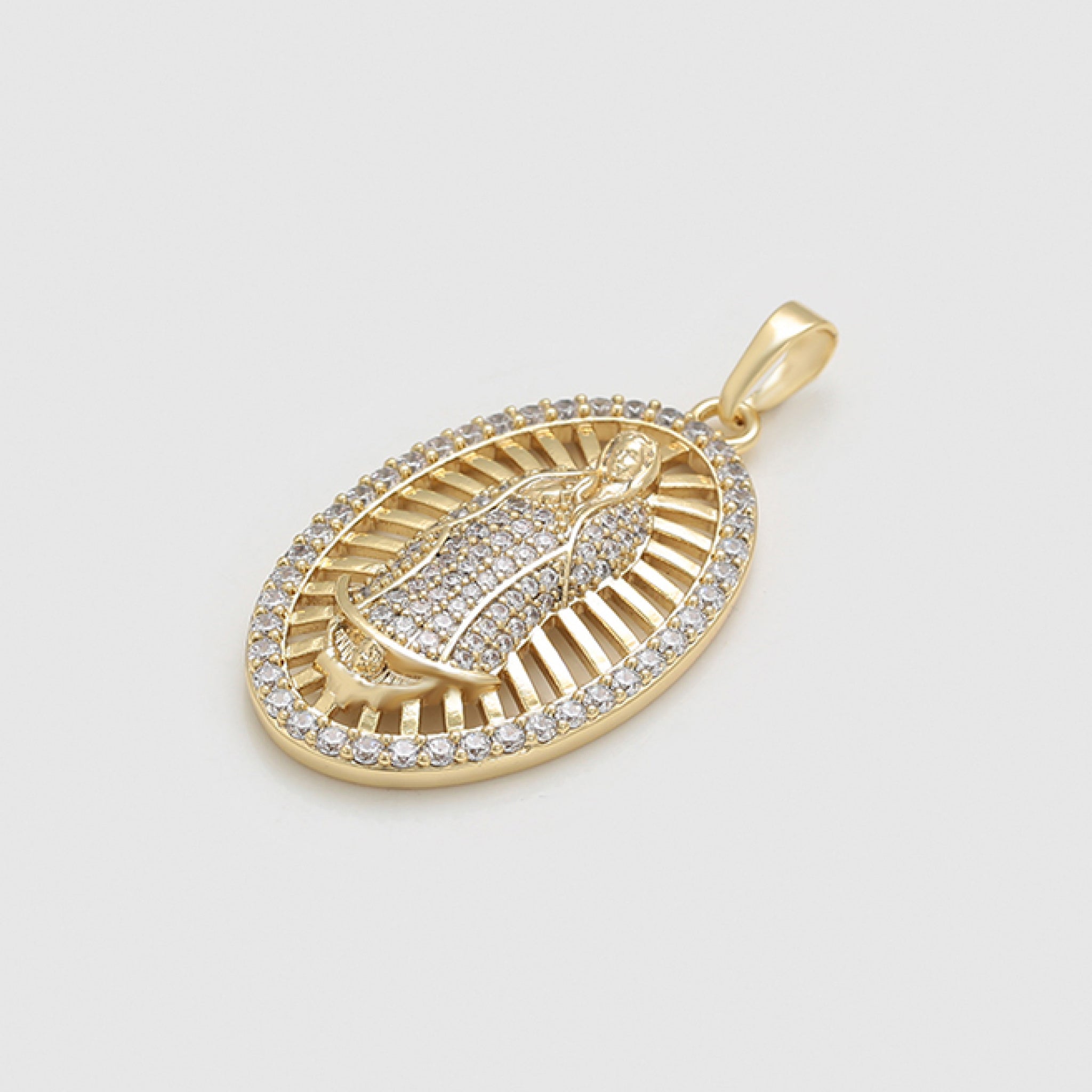 Gold pendant with intricate design on a light gray background