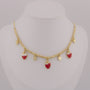 Gold necklace with strawberry-shaped charms on a mannequin bust.
