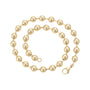 Gold beaded necklace on a white background