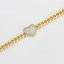 Gold chain bracelet with a heart-shaped diamond clasp on a light gray background