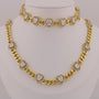 Gold necklace with heart-shaped diamond pendants on a mannequin.