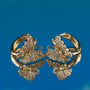Gold butterfly earrings on a blue background