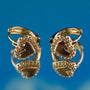 Gold heart-shaped earrings on a blue background