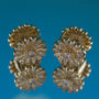 Gold earrings with diamond-like stones on a blue background