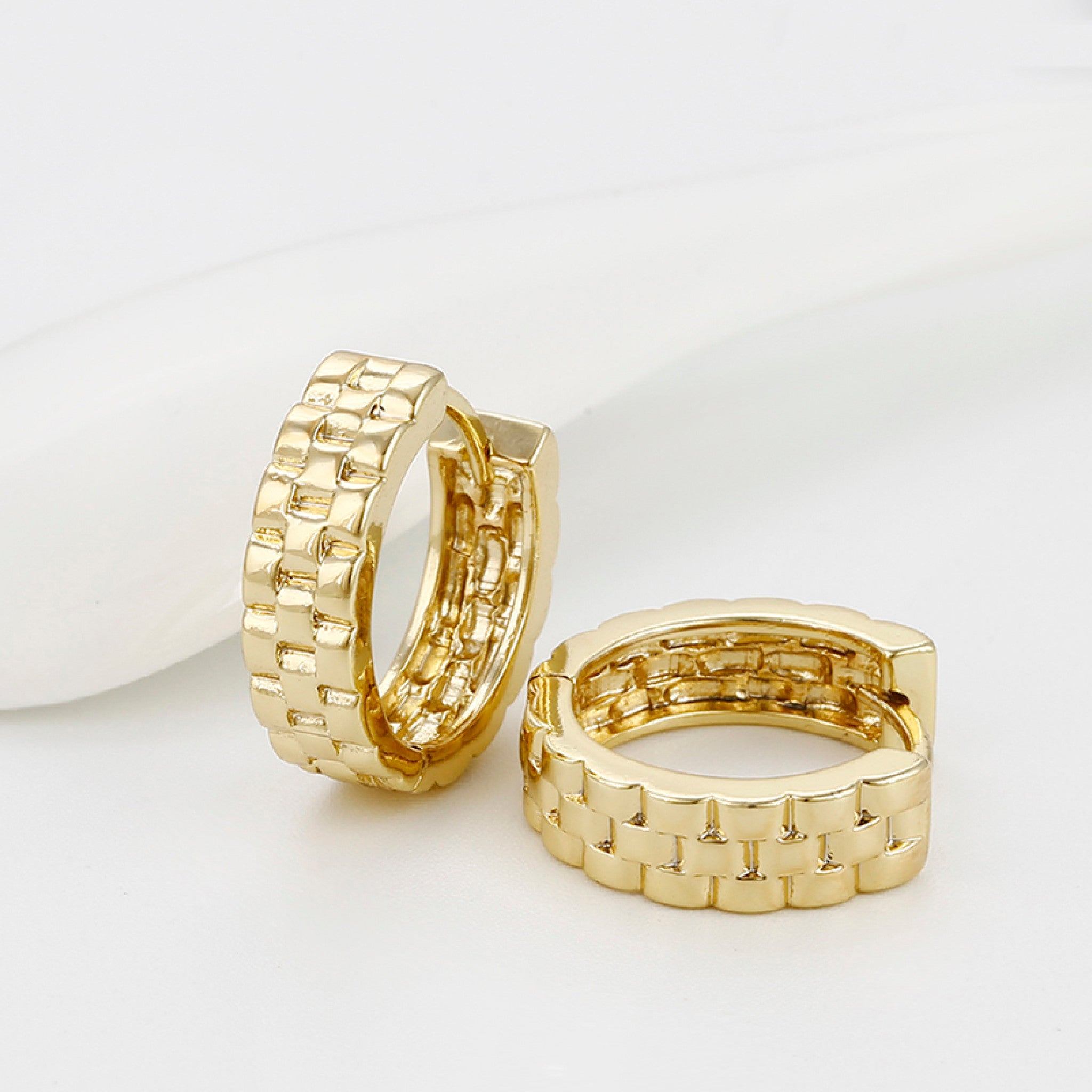Gold hoop earrings on a white background