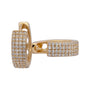 Gold earrings with diamond accents on a white background