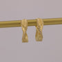 Gold curtain rod with decorative finials on a gray background
