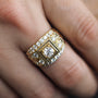 Gold ring with diamonds on a finger