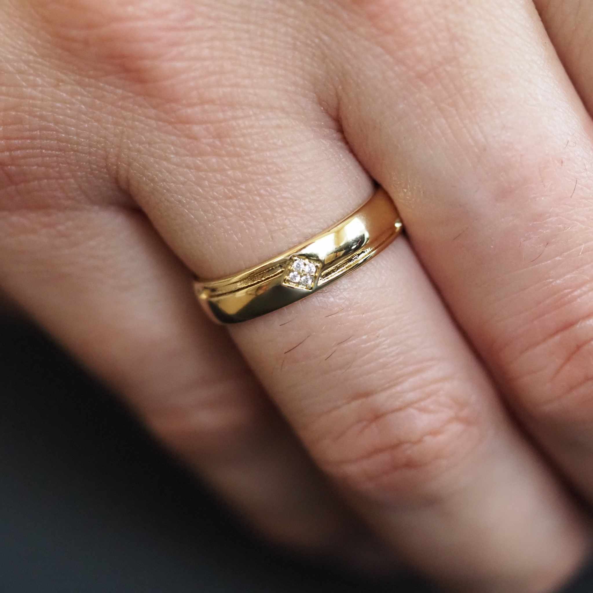 Gold ring with a diamond on a finger