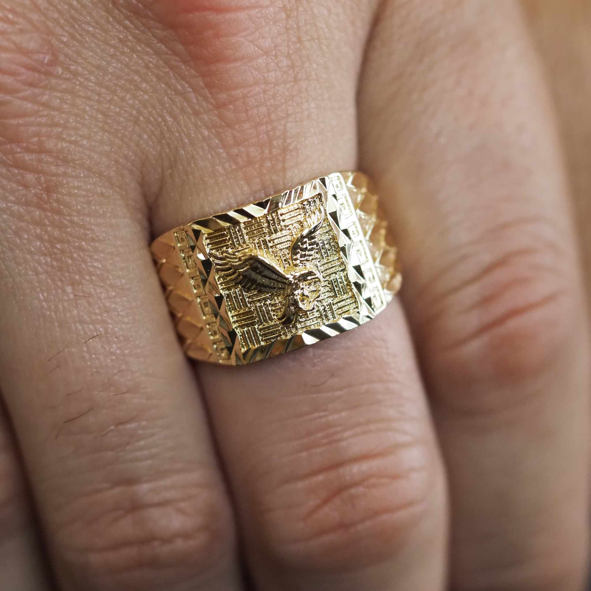Gold textured ring on a finger