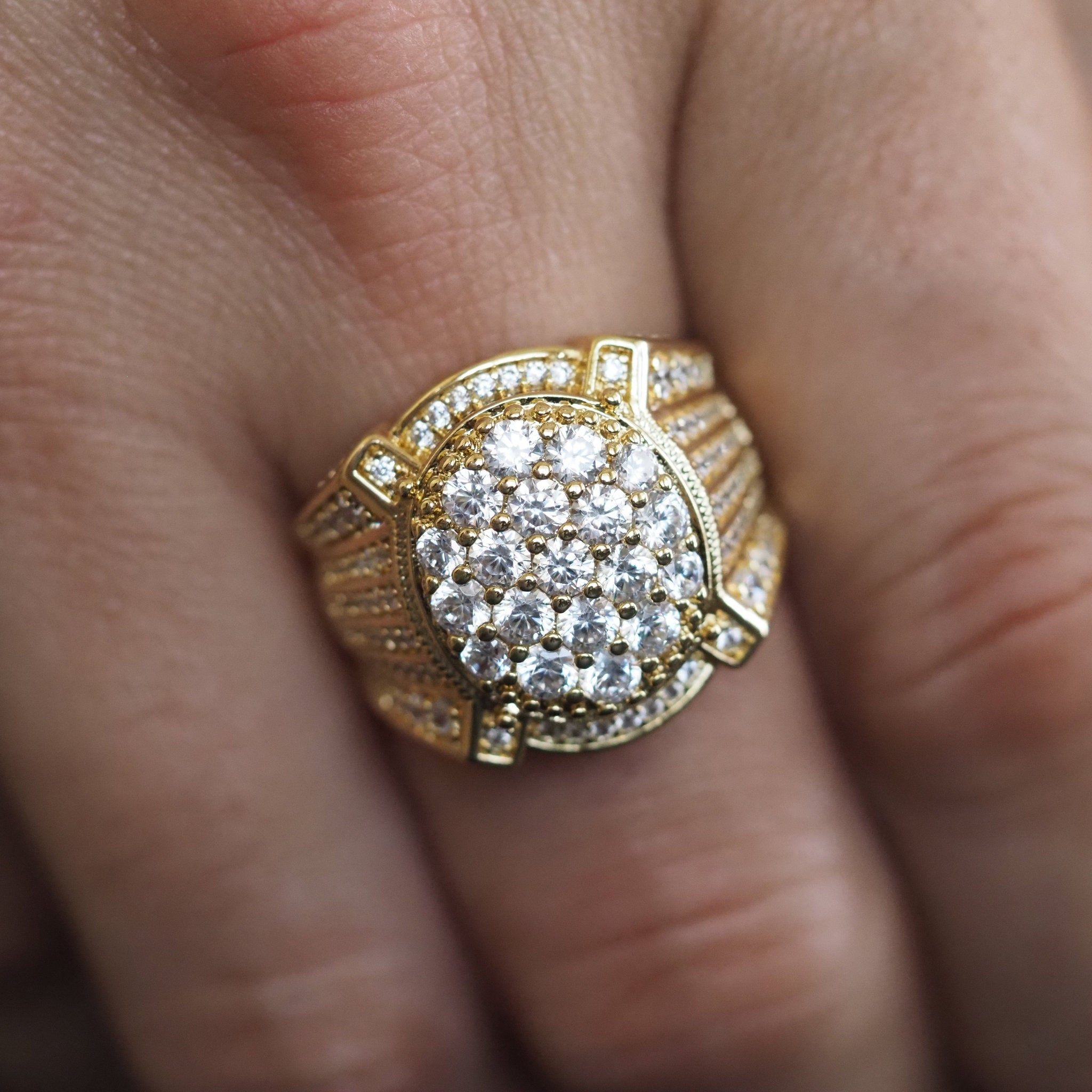 Gold ring with diamonds on a finger