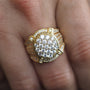 Gold ring with diamonds on a finger