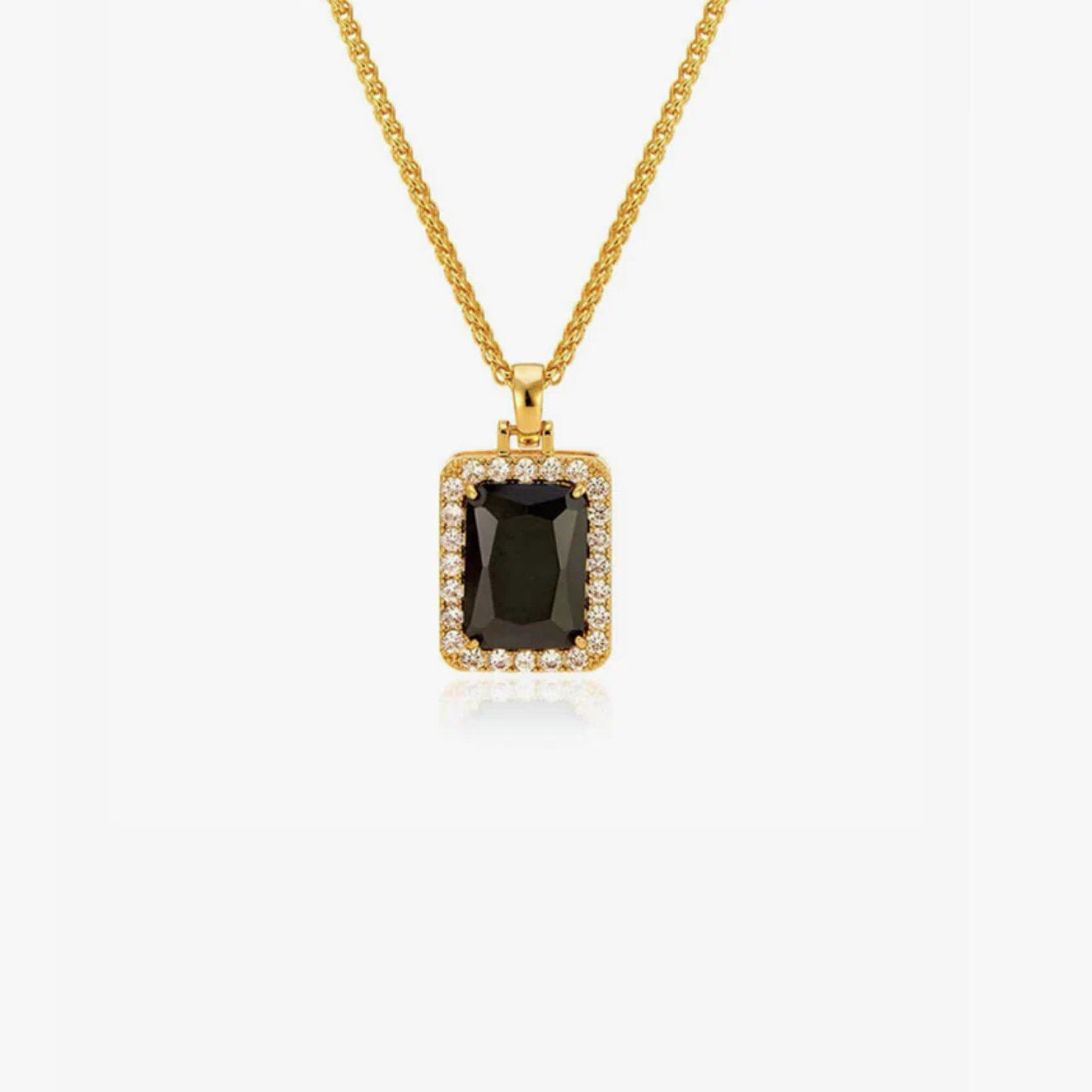 Gold necklace with a black gemstone pendant on a white background