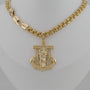 Gold chain necklace with an anchor pendant on a mannequin bust.