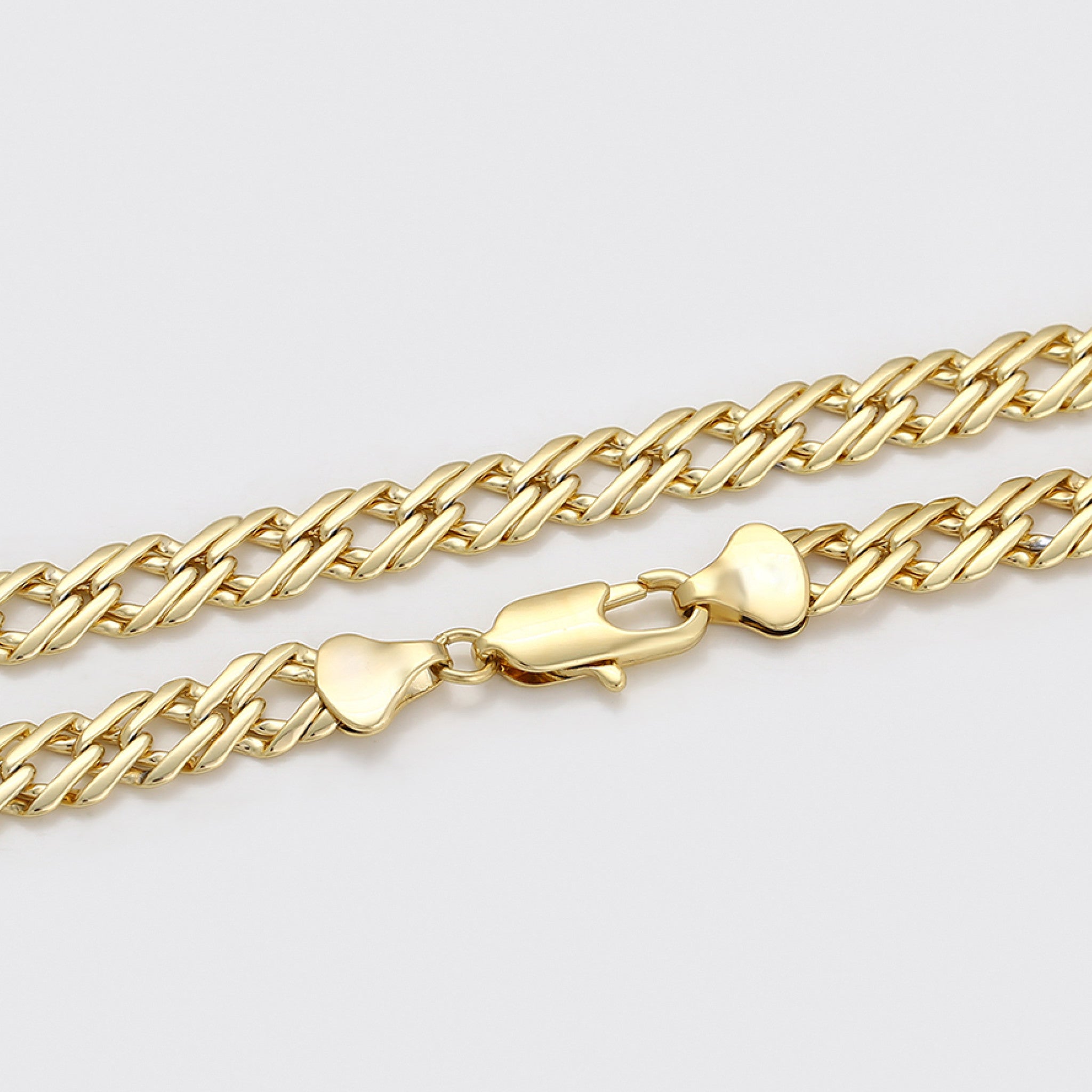 Gold chain bracelet with a clasp on a light gray background