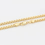 Gold chain necklace on a light gray background