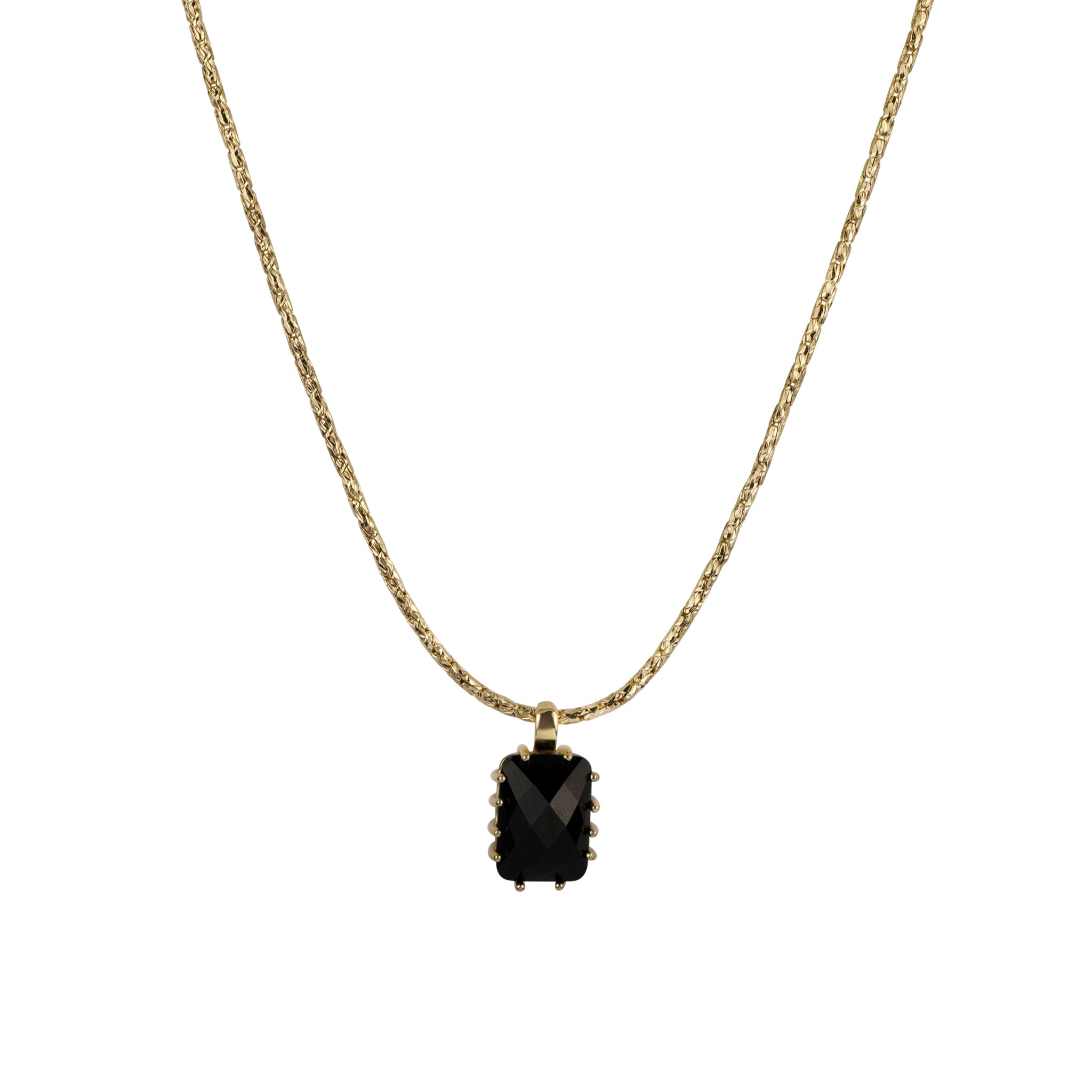 Gold necklace with a black pendant on a white background