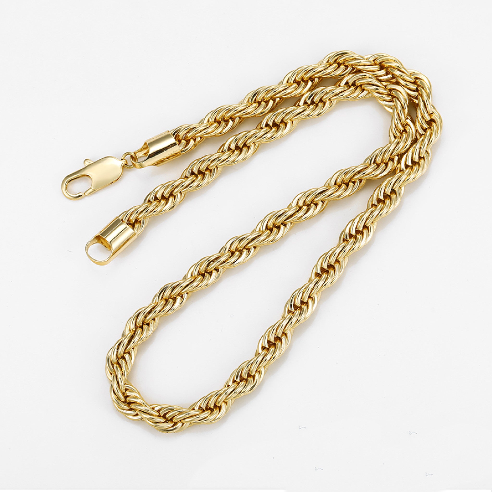 Gold rope chain necklace on a white background