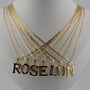 Gold necklaces with 'ROSELUN' pendant on a mannequin