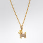 Gold dog-shaped pendant necklace on a light gray background