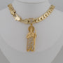 Gold necklace with a detailed pendant on a mannequin neck.