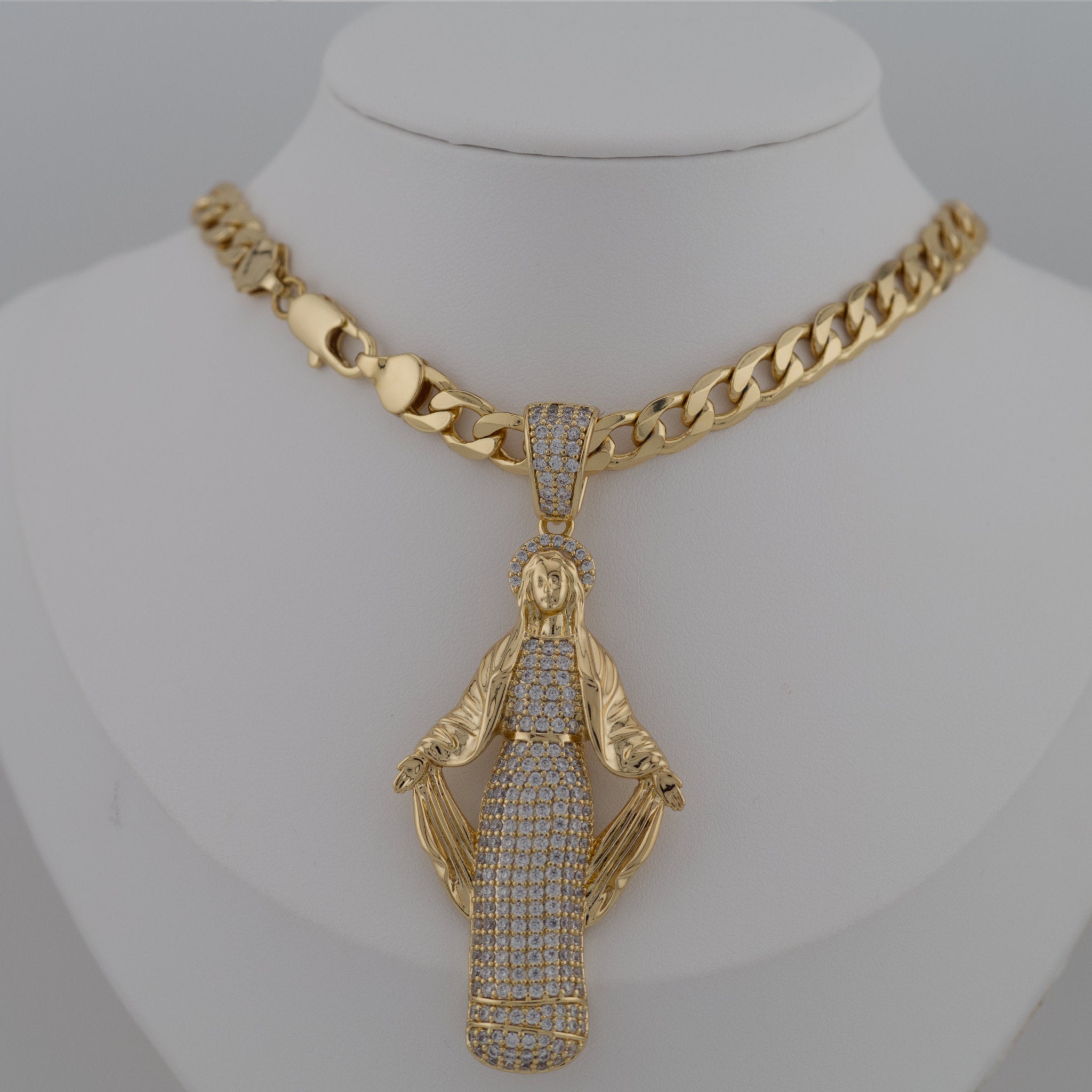 Gold necklace with a detailed pendant on Virgin Mary.