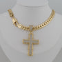 Gold chain necklace with a cross pendant on a mannequin.