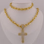 Gold chain necklace with a cross pendant on a mannequin bust.