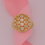 Gold ring with hexagonal pattern on a pink ribbon