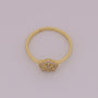 Gold ring with a decorative design on a light gray background