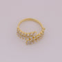 Gold ring with intricate design on a light gray background