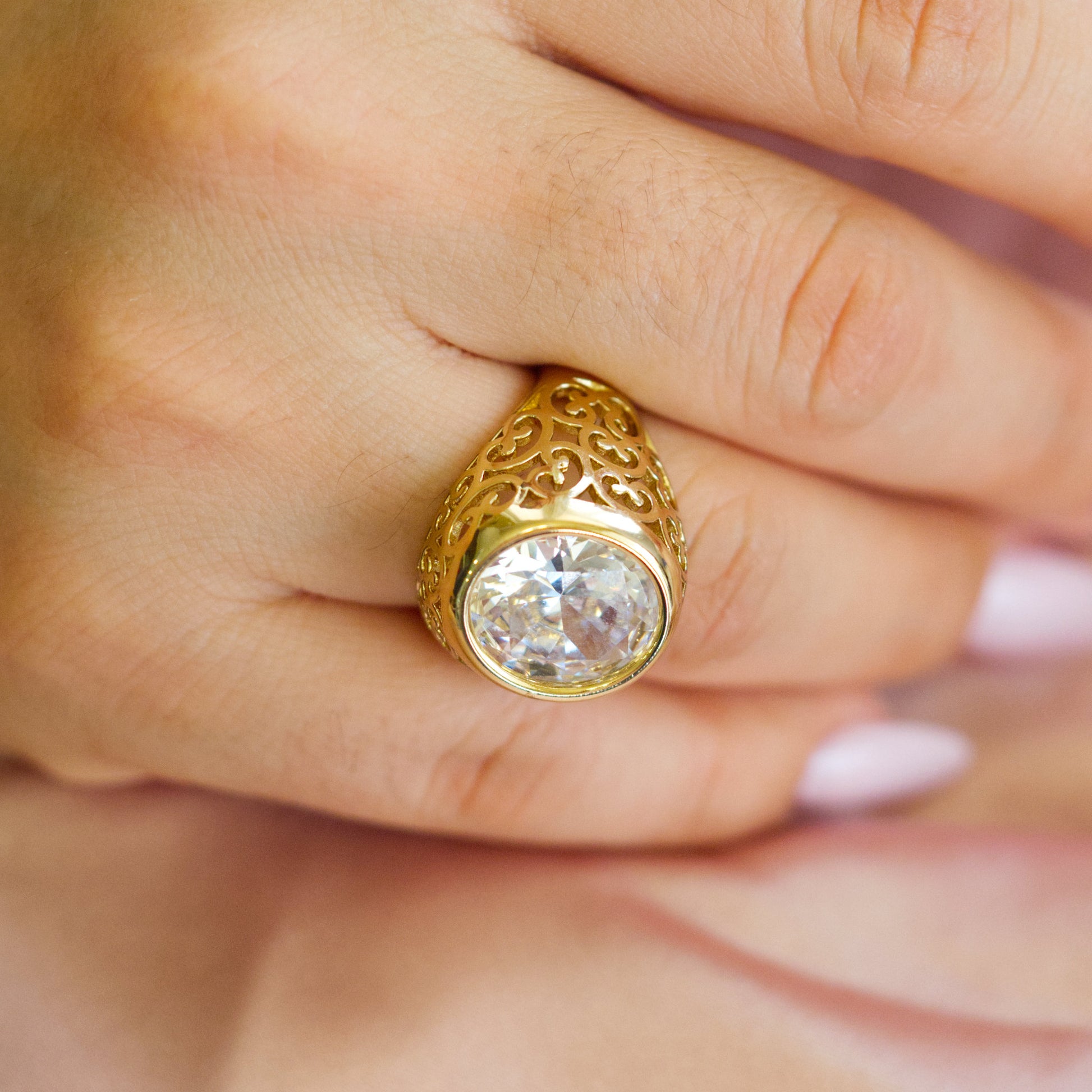 Gold ring with a diamond on a hand
