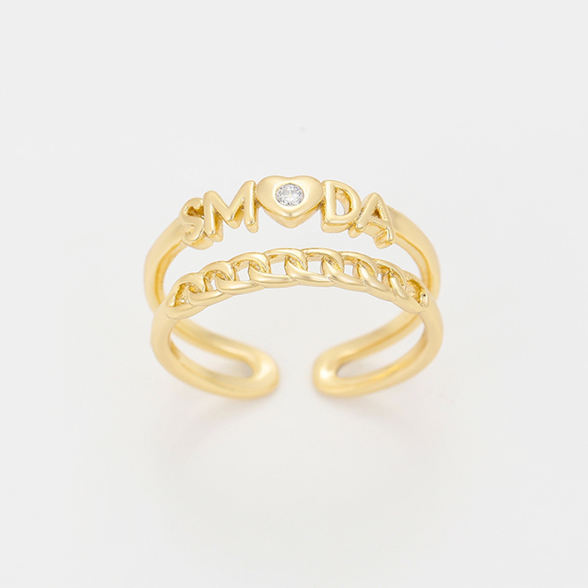 Gold ring with 'LOVE' and 'MOM' text on a light gray background
