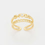 Gold ring with 'LOVE' and 'MOM' text on a light gray background