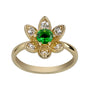 Gold ring with a green gemstone and diamond accents on a white background